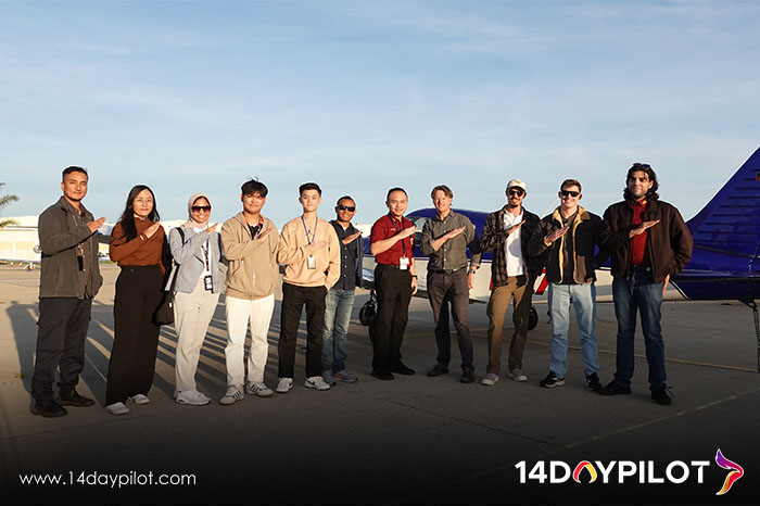 Group of 14DAYPILOT students posing outside aircraft after passing pilot license exam