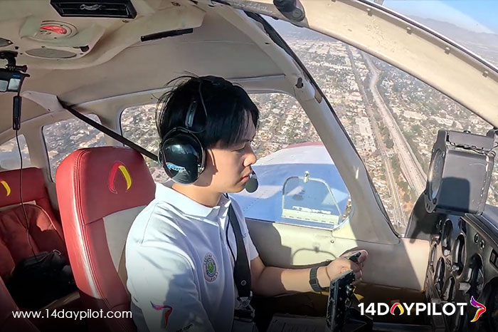14DAYPILOT Student practicing air traffic control communication in real flight training.